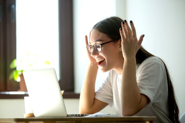 lady receives good news via her laptop